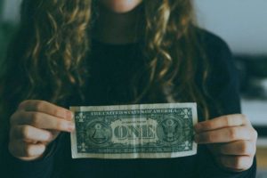 photo-of-a-young-woman -holding-a-dollar-bill