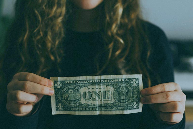 photo-of-a-young-woman -holding-a-dollar-bill